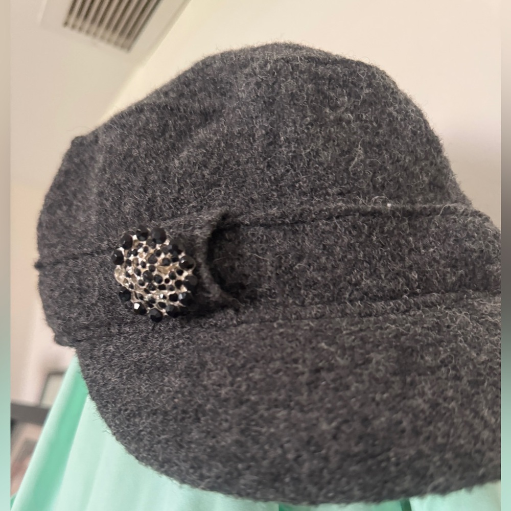 100% wool cap.  Dark gray with brooch.  5’ high, 6’ across.